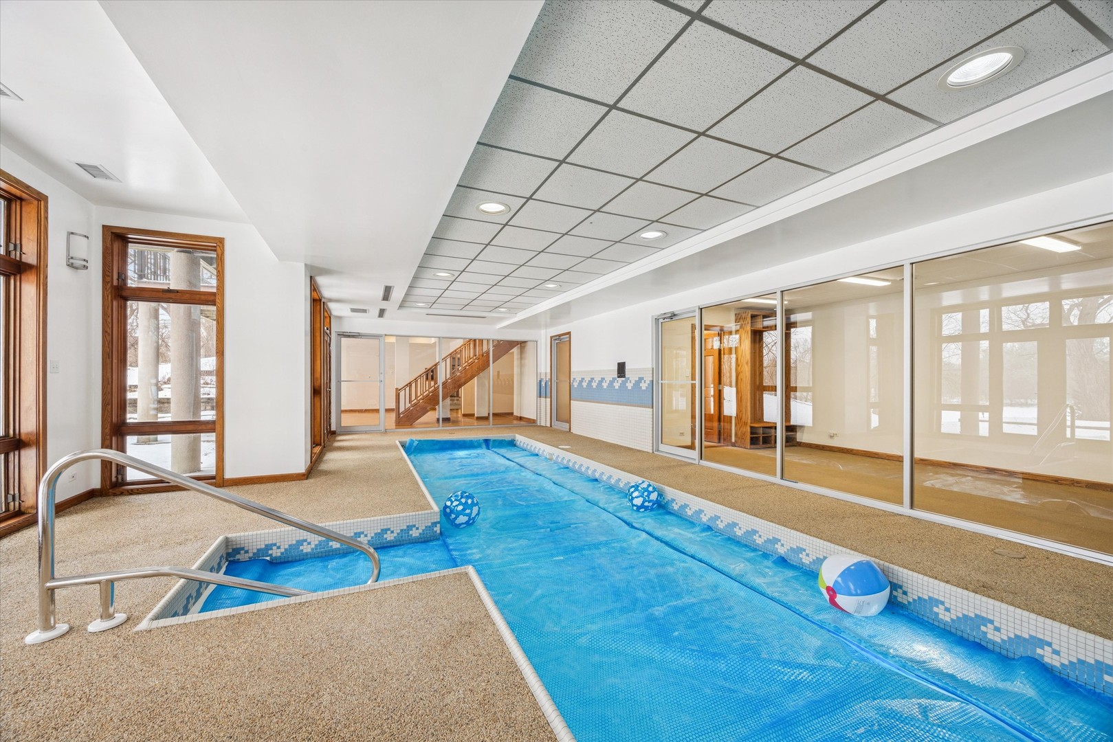 8425 Hickory Court Burr Ridge, IL 60527 - Photo 39 of 53 a room with gym equipment and large windows