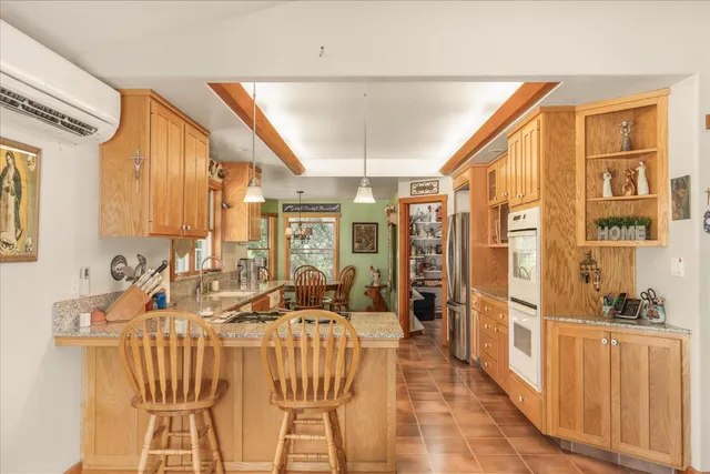 a living room with furniture a flat screen tv and a large window