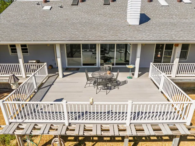 a backyard of a house with table and chairs