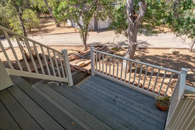 a living room with furniture a flat screen tv and a large window