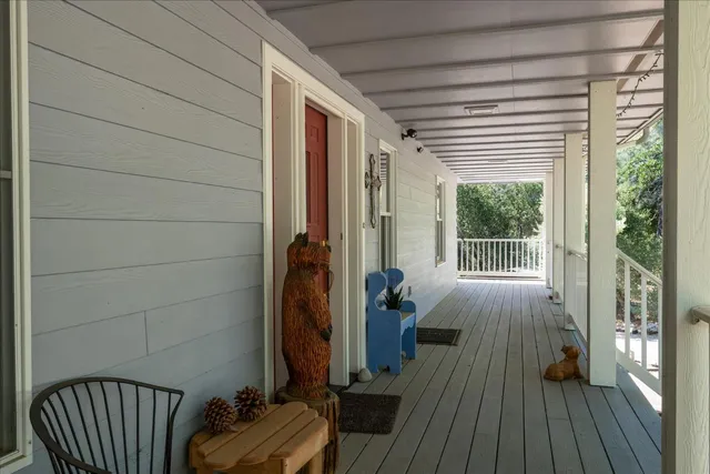 a living room with furniture a flat screen tv and a large window