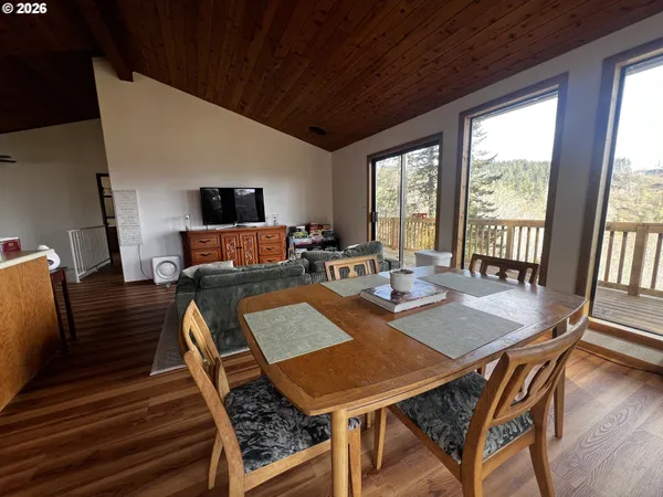 a view of a dining room with furniture window and wooden floor
