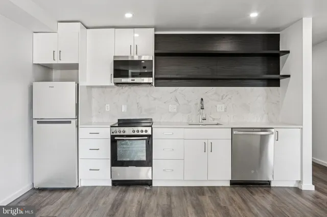 a kitchen with stainless steel appliances a stove and a refrigerator