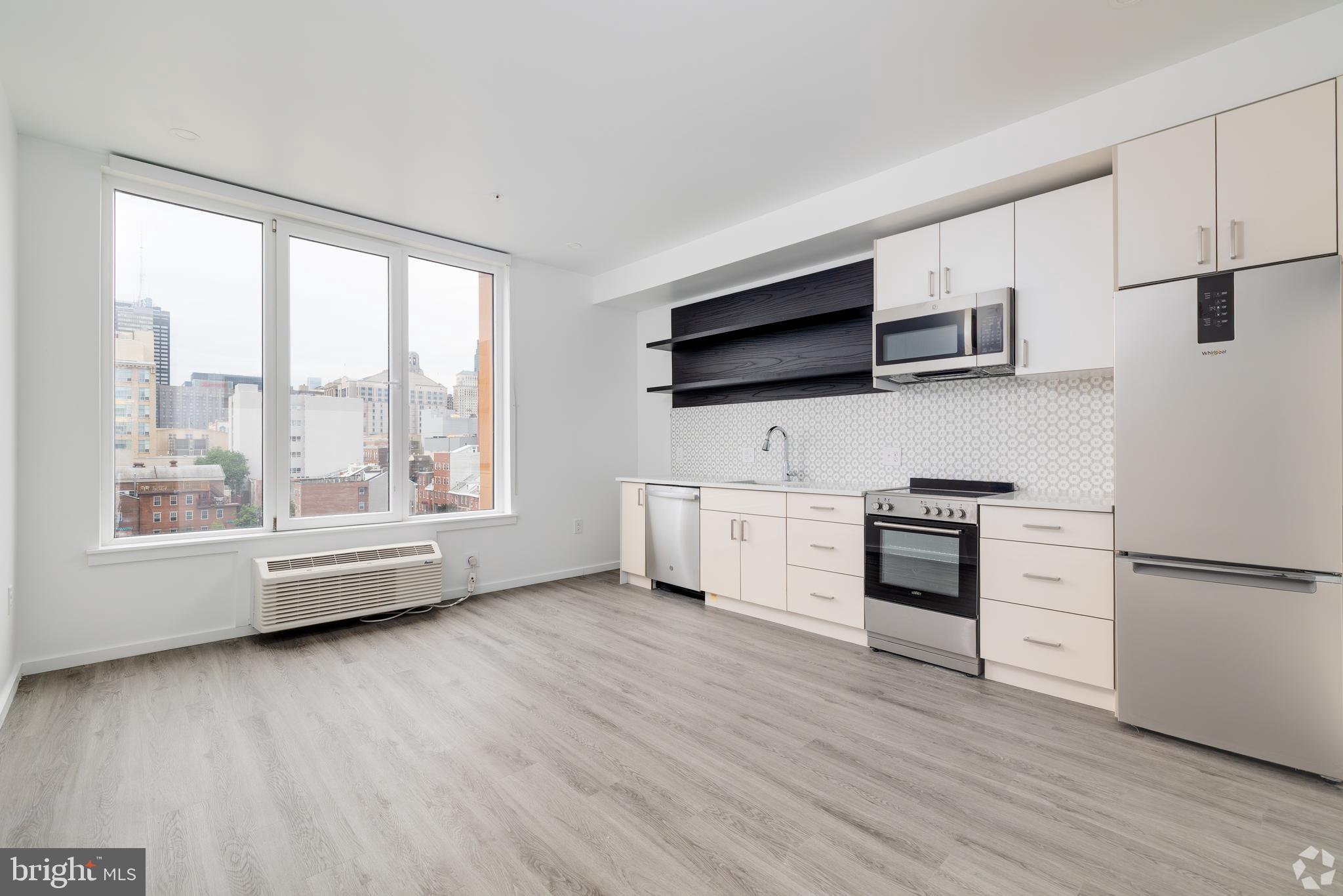 1201 Vine Street, Unit 1 Philadelphia, PA 19107 - Photo 13 of 32 a kitchen with stainless steel appliances a refrigerator and a stove top oven