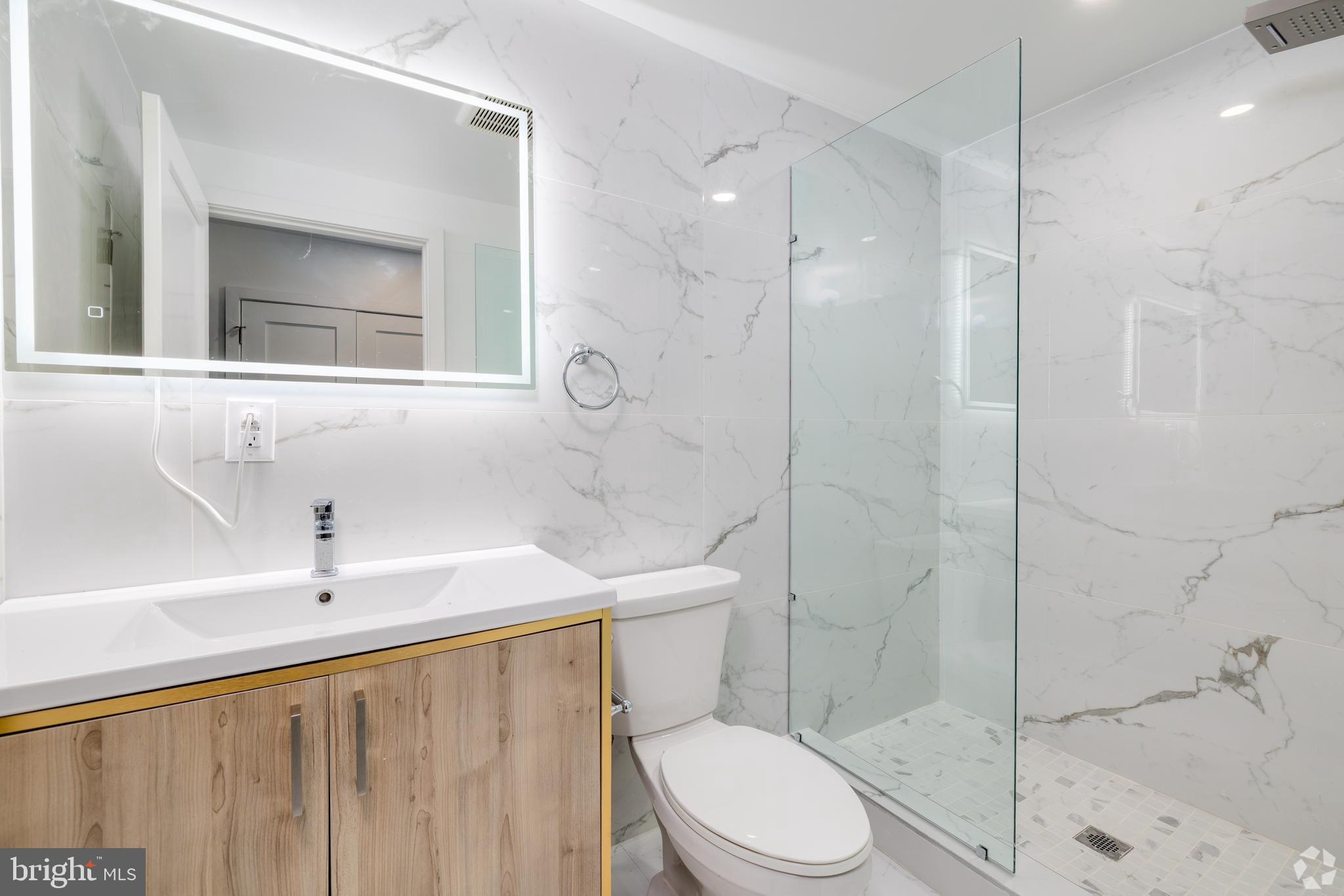 1201 Vine Street, Unit 1 Philadelphia, PA 19107 - Photo 17 of 32 a bathroom with a toilet a sink and shower