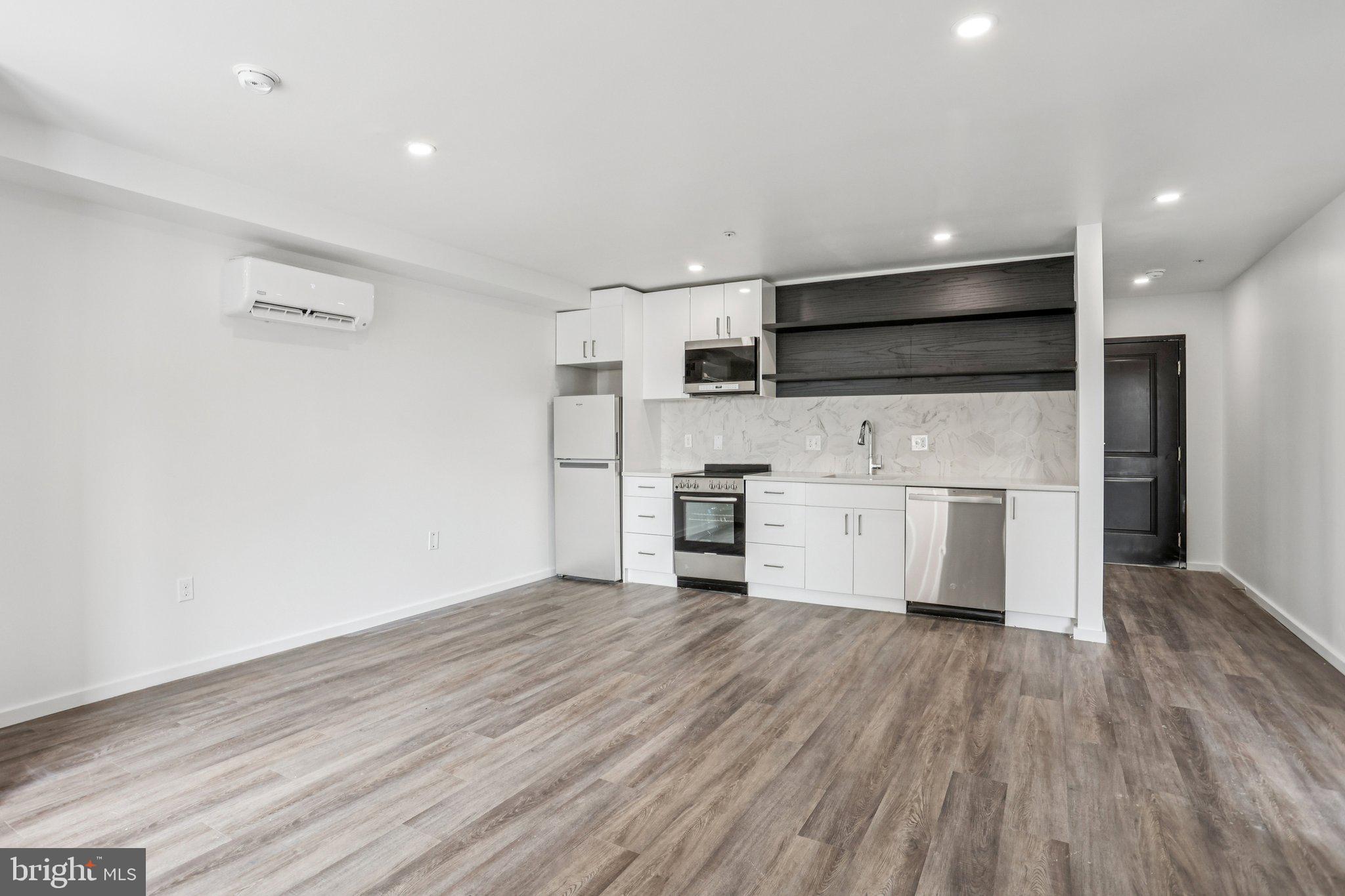 1201 Vine Street, Unit 1 Philadelphia, PA 19107 - Photo 2 of 32 a view of kitchen view wooden floor cabinets and stainless steel appliances