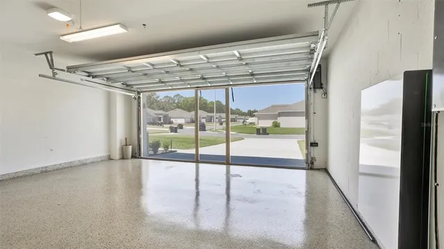 a view of an empty room with wooden floor and windows