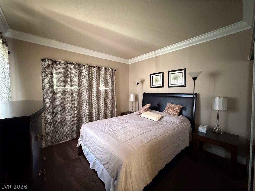 210 East Flamingo Road, Unit 426 Las Vegas, NV 89169 - Photo 16 of 17 Comfortable bedroom with classic crown molding, perfect for relaxation.