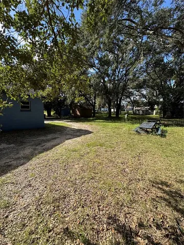 a view of outdoor space with deck and trees
