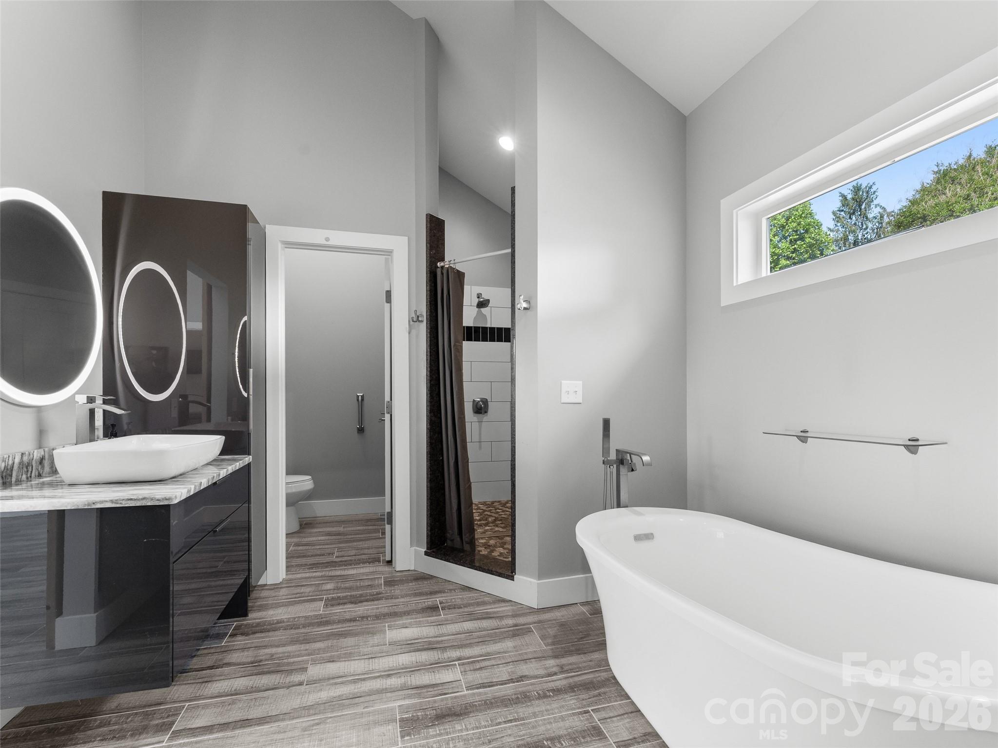 123 Israel Road Candler, NC 28715 - Photo 24 of 44 a bathroom with a tub sink and mirror