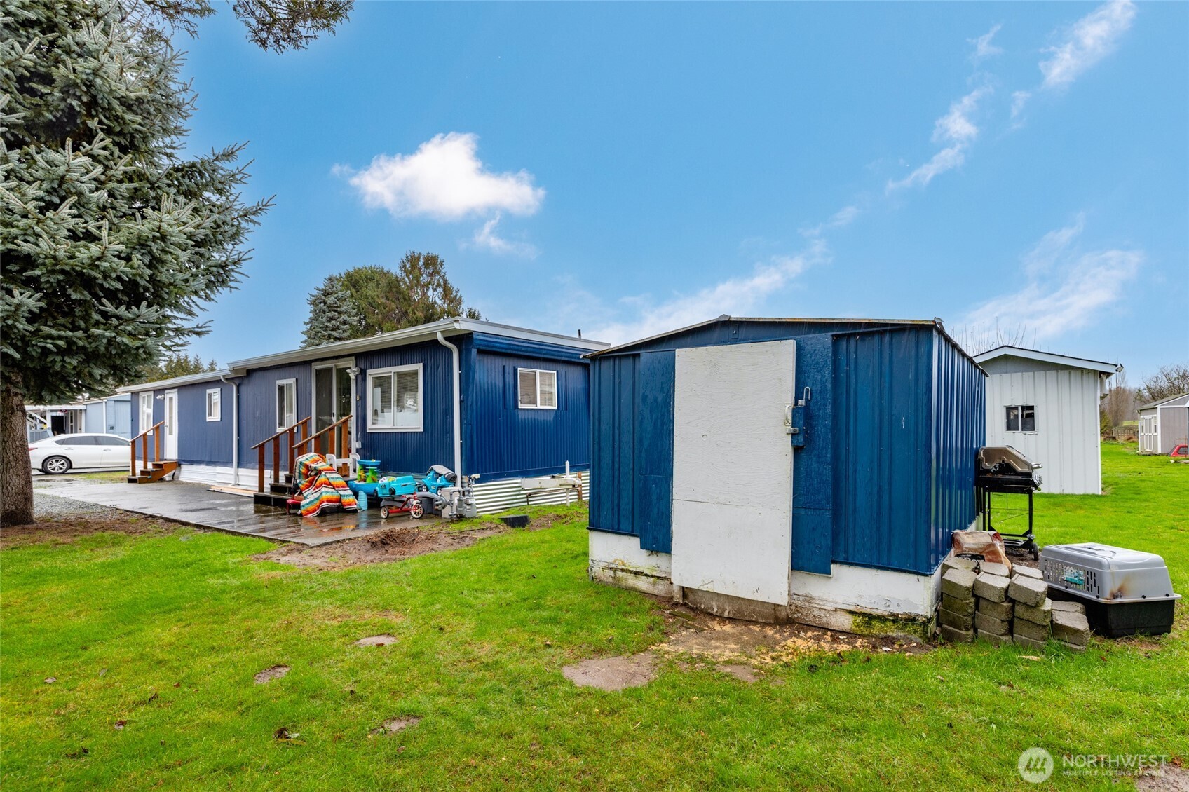 20420 Lafayette Road, Unit 11 Burlington, WA 98233 - Photo 13 of 14 a view of a backyard with table and chairs and a barbeque