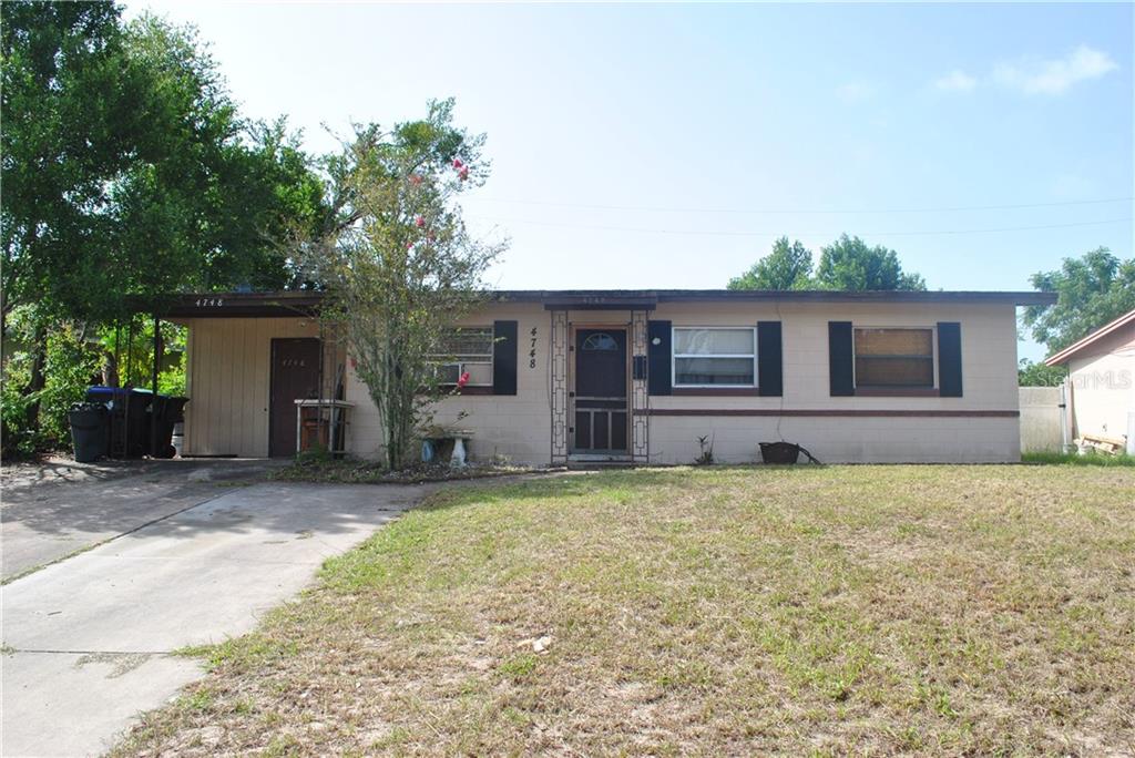 4748 Elkmont Road Orlando, FL 32808 - Photo 1 of 1 a house view with a backyard space