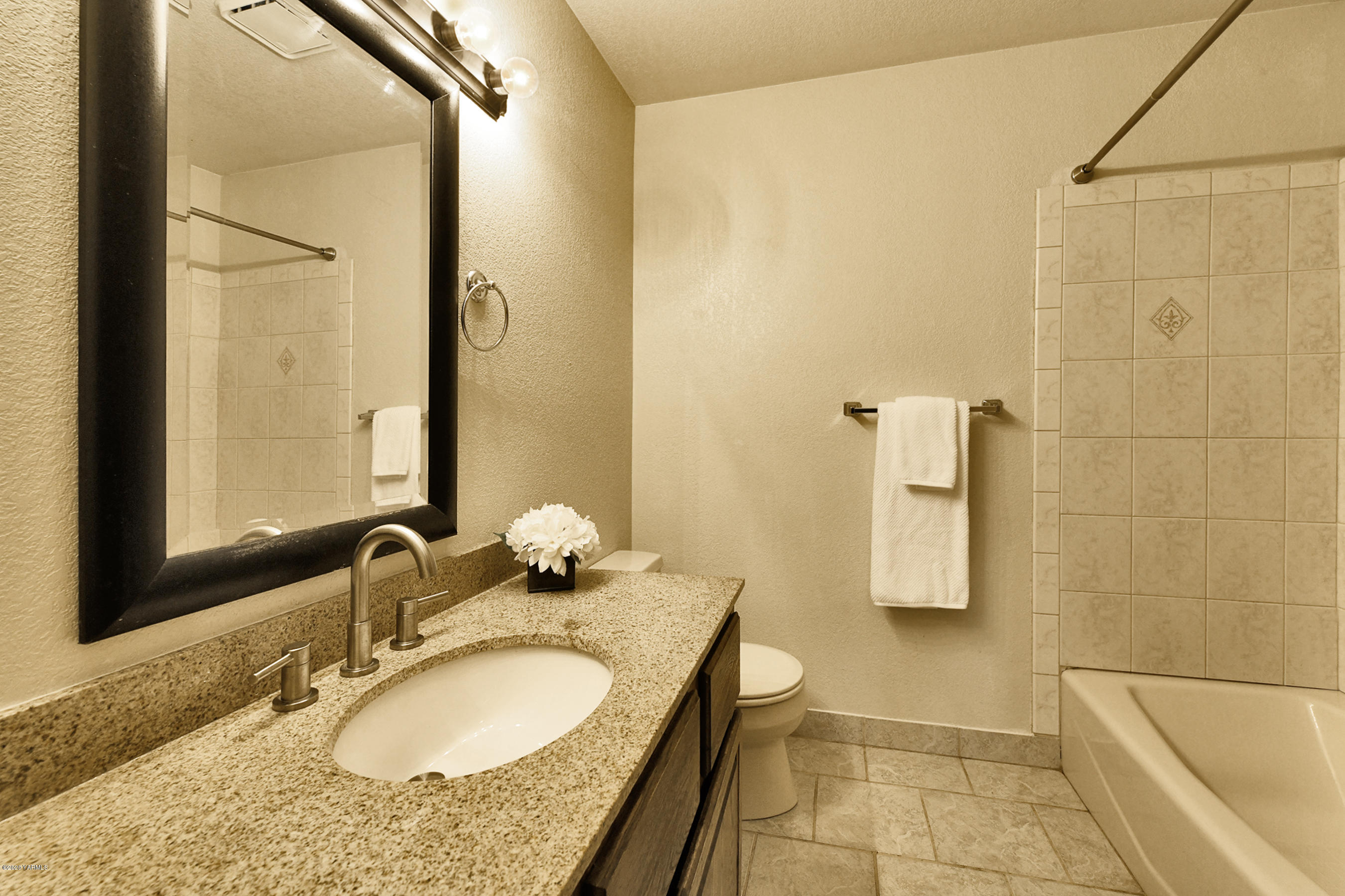 13010 Rutherford Road Yakima, WA 98903 - Photo 15 of 39 a bathroom with a granite countertop sink and a mirror