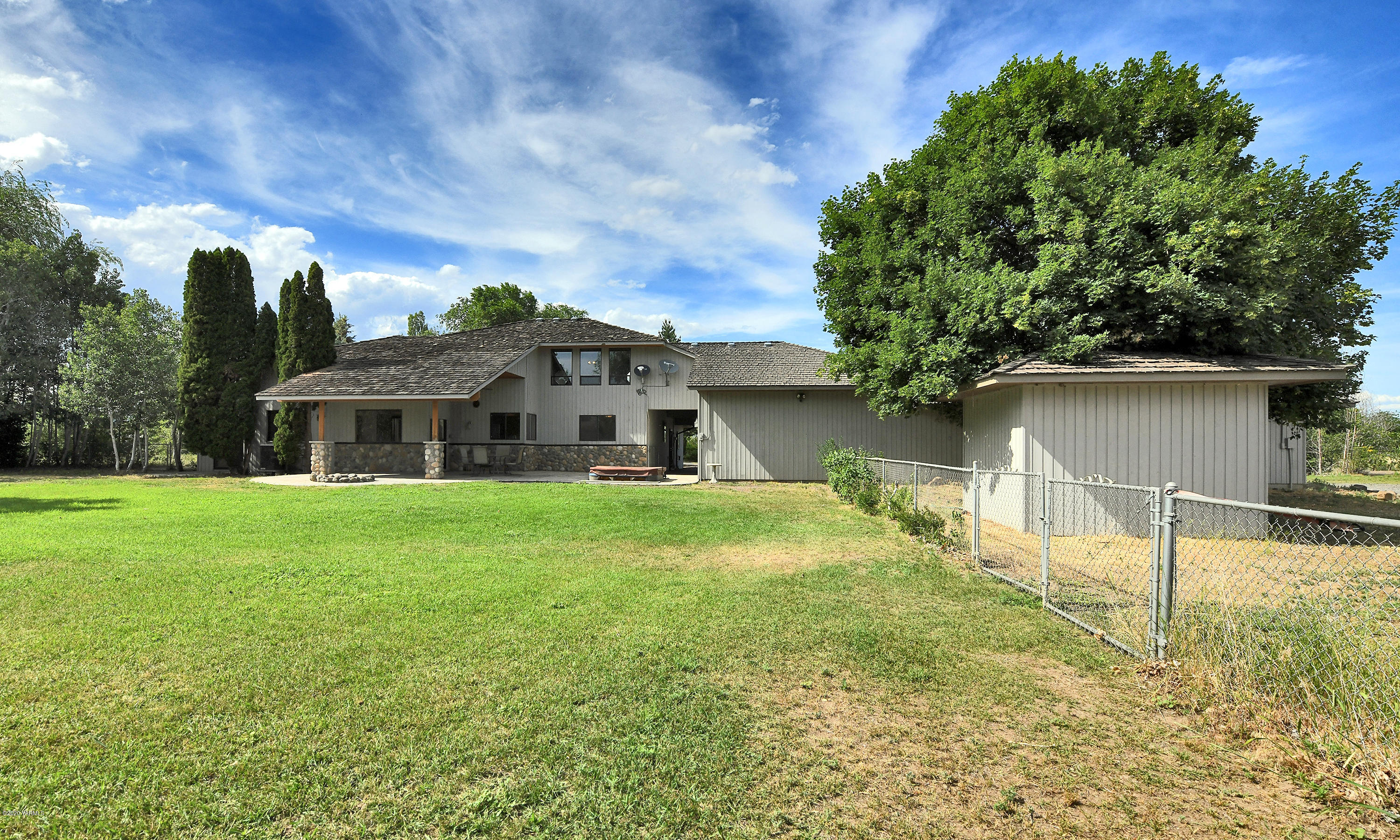 13010 Rutherford Road Yakima, WA 98903 - Photo 27 of 39 a front view of house with yard and trees in the background