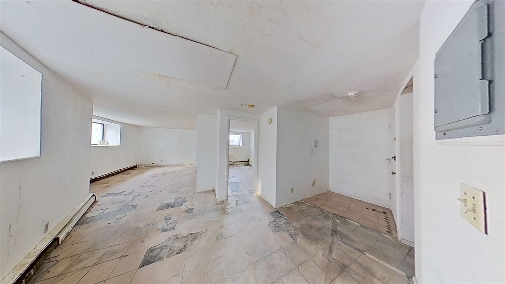 30 Kinross Road, Unit 1 Boston, MA 02135 - Photo 13 of 17 a view of a bathroom with a sink and a mirror