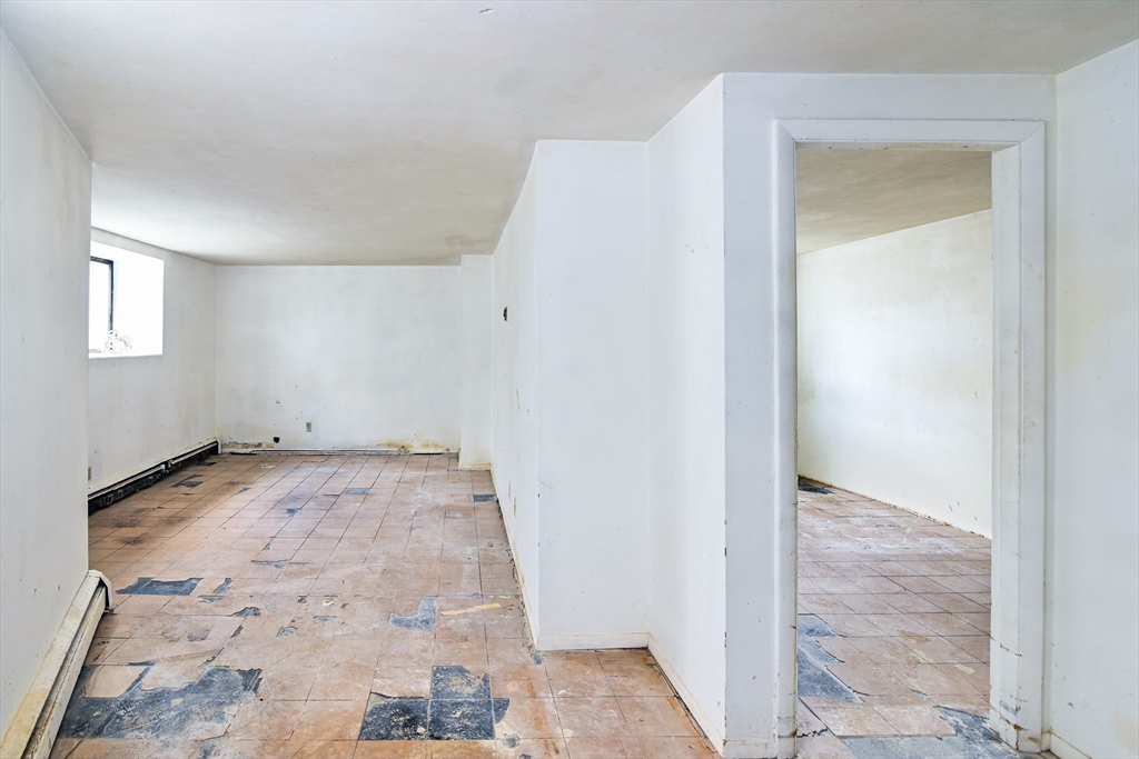 30 Kinross Road, Unit 1 Boston, MA 02135 - Photo 4 of 17 an empty room with a bench