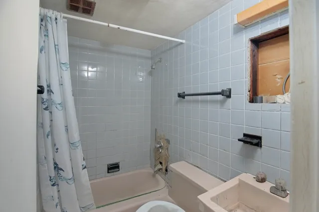 a bathroom with a shower and a toilet