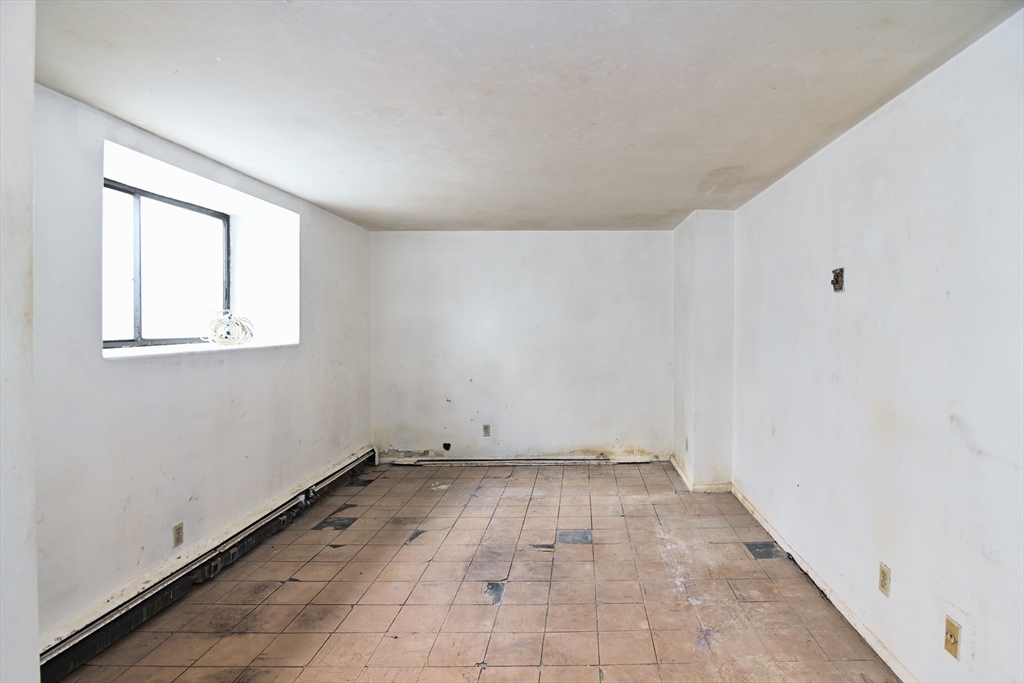 30 Kinross Road, Unit 1 Boston, MA 02135 - Photo 9 of 17 an empty room with windows