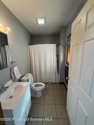 a bedroom with a bed and a television