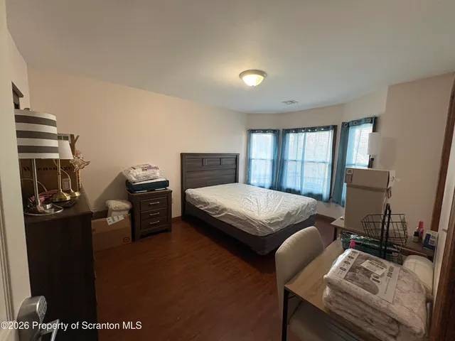 a bedroom with a bed and a mirror