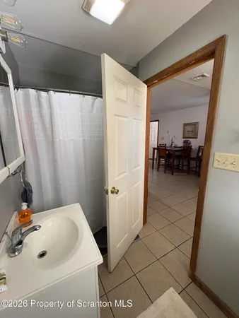 a bathroom with a sink a mirror and shower