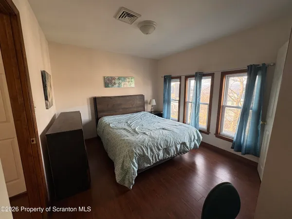 a bedroom with a bed and a mirror