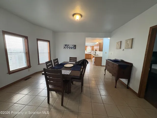 a view of a dining room with furniture and window