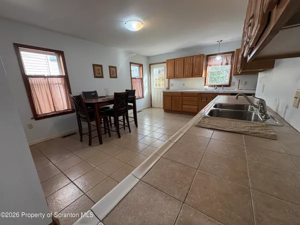 a living room with furniture a flat screen tv and windows