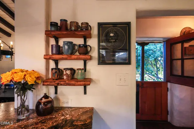 a kitchen with a stove and a clock on the wall