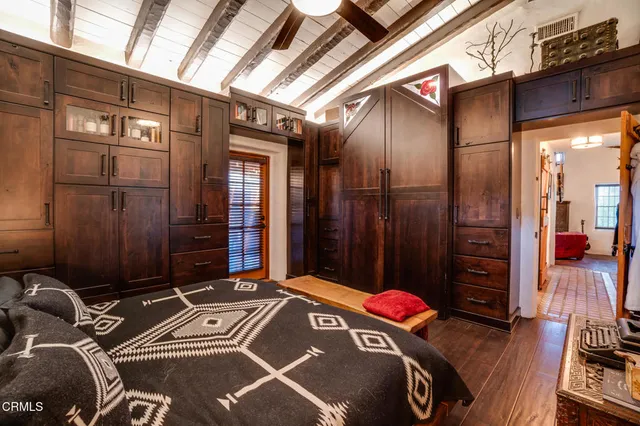 a view of a livingroom with wooden floor and a flat screen tv