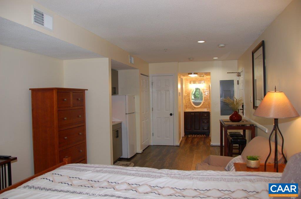 2076 Stone Ridge Wintergreen, VA 22967 - Photo 2 of 4 a bedroom with a bed and a dresser