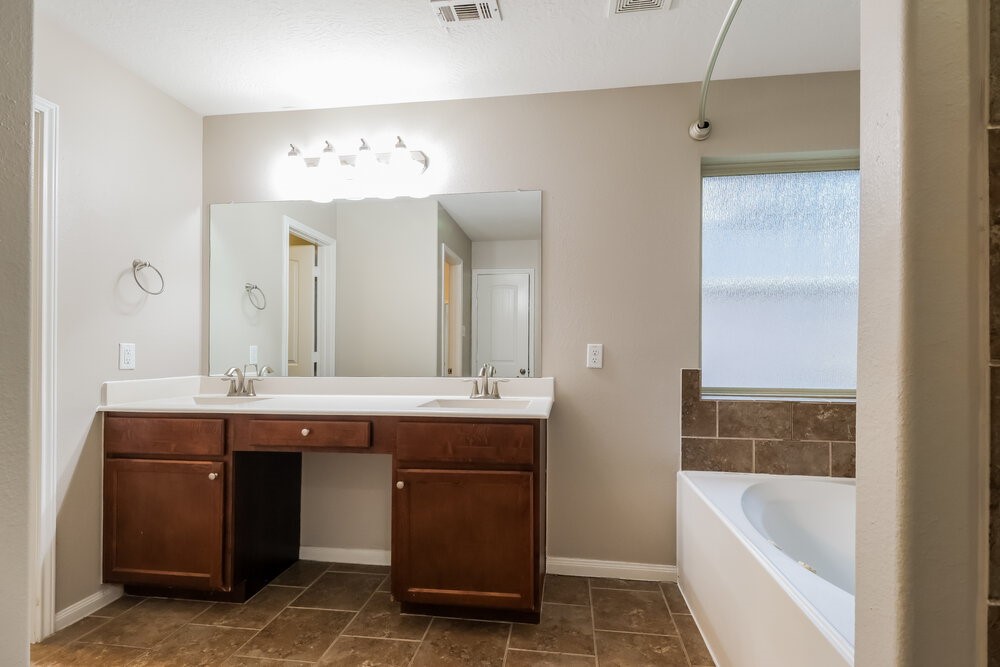 226 Fantasy Lane Montgomery, TX 77356 - Photo 12 of 17 a bathroom with a tub a sink and mirror