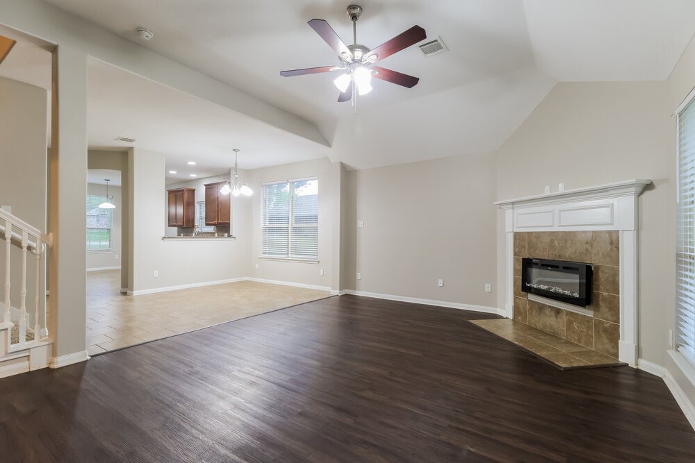 226 Fantasy Lane Montgomery, TX 77356 - Photo 5 of 17 a view of an empty room with a kitchen and a fireplace