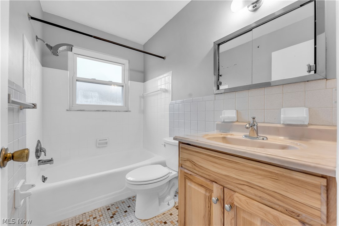 2915 Snow Road, Unit 2/UP Cleveland, OH 44134 - Photo 14 of 23 Bathroom featuring a wood-finish vanity with an integrated sink and a mirrored medicine cabinet