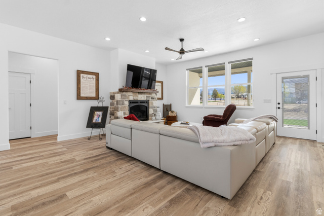 886 North 300th East Spring City, UT 84662 - Photo 12 of 40 Living room featuring a stone fireplace, light wood-type flooring, recessed lighting, and ceiling fan