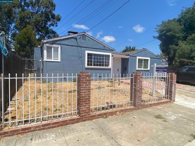 a view of a house with wooden fence