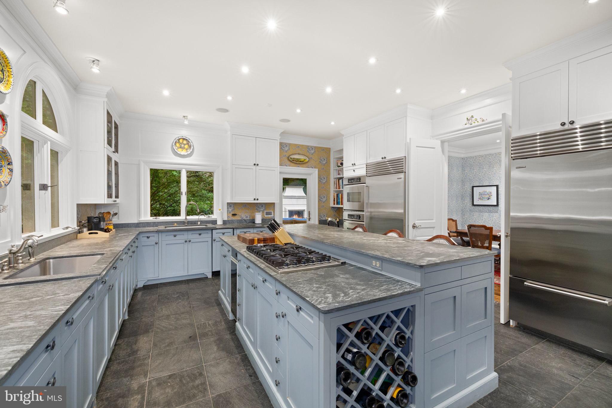 1111 Crest Lane McLean, VA 22101 - Photo 13 of 61 a kitchen with kitchen island granite countertop a sink stove and cabinets