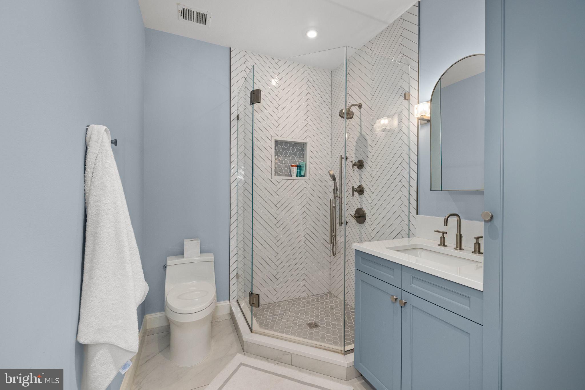 1111 Crest Lane McLean, VA 22101 - Photo 35 of 61 a bathroom with a shower sink vanity and toilet