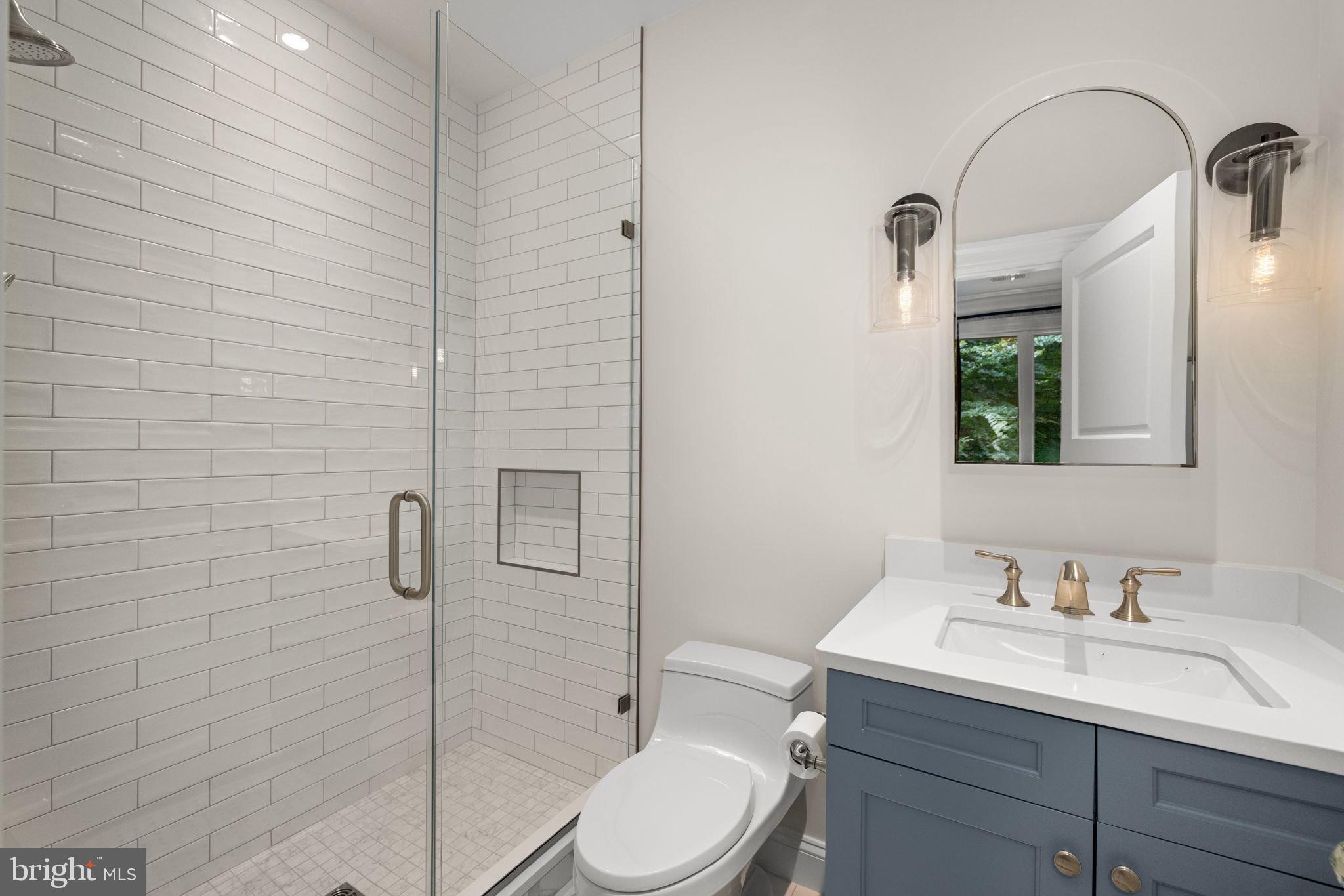 1111 Crest Lane McLean, VA 22101 - Photo 37 of 61 a bathroom with a granite countertop sink toilet and shower