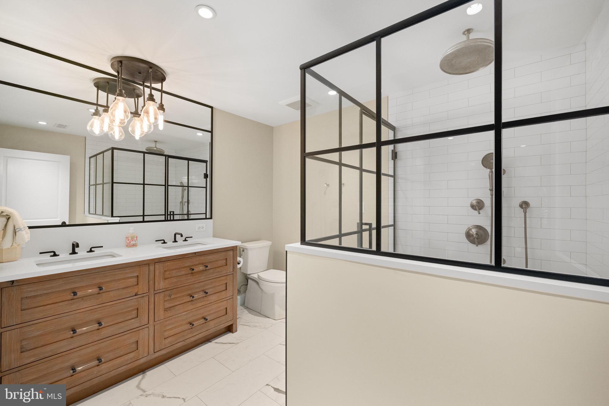 1111 Crest Lane McLean, VA 22101 - Photo 52 of 61 a bathroom with a double vanity sink and mirror