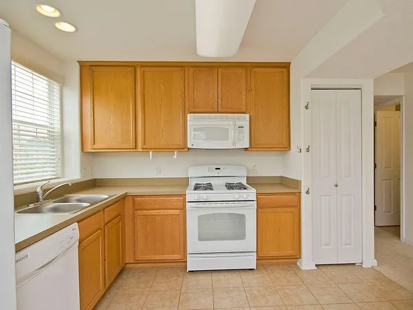a kitchen with a stove sink and cabinets
