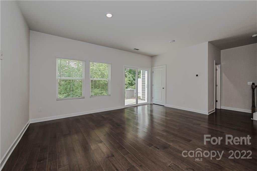 3534 Auburn Curb Road Charlotte, NC 28217 - Photo 2 of 11 an empty room with wooden floor and windows