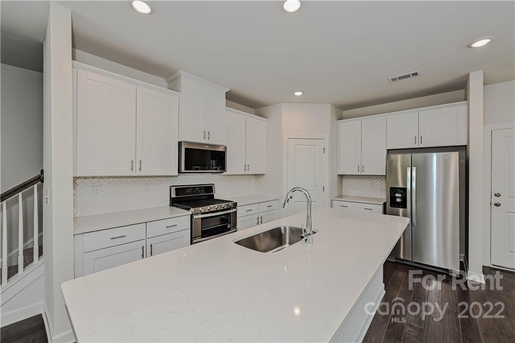 3534 Auburn Curb Road Charlotte, NC 28217 - Photo 4 of 11 a kitchen with stainless steel appliances granite countertop a refrigerator stove microwave and sink