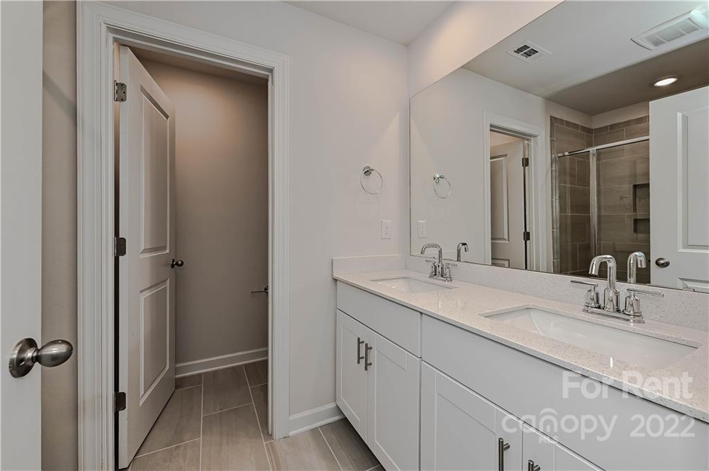 3534 Auburn Curb Road Charlotte, NC 28217 - Photo 8 of 11 a bathroom with double sink and a mirror
