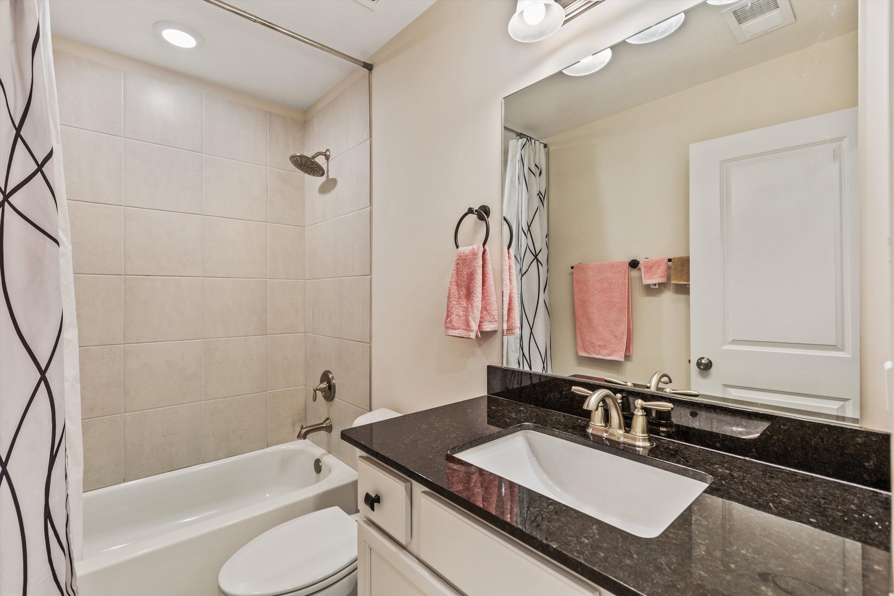 10139 Macon Road Cordova, TN 38018 - Photo 26 of 31 Bathroom featuring a vanity with a dark countertop, an undermount sink, and a brushed nickel faucet