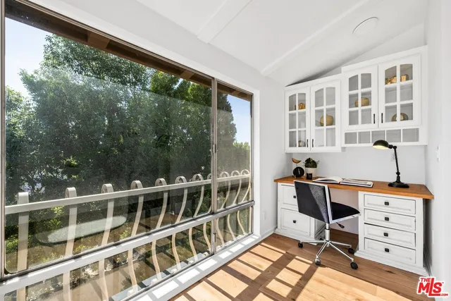 a view of a bedroom with furniture and windows