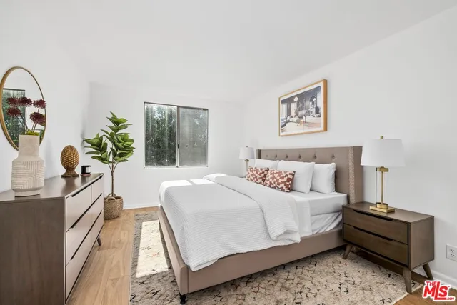 a bedroom with bed and a window