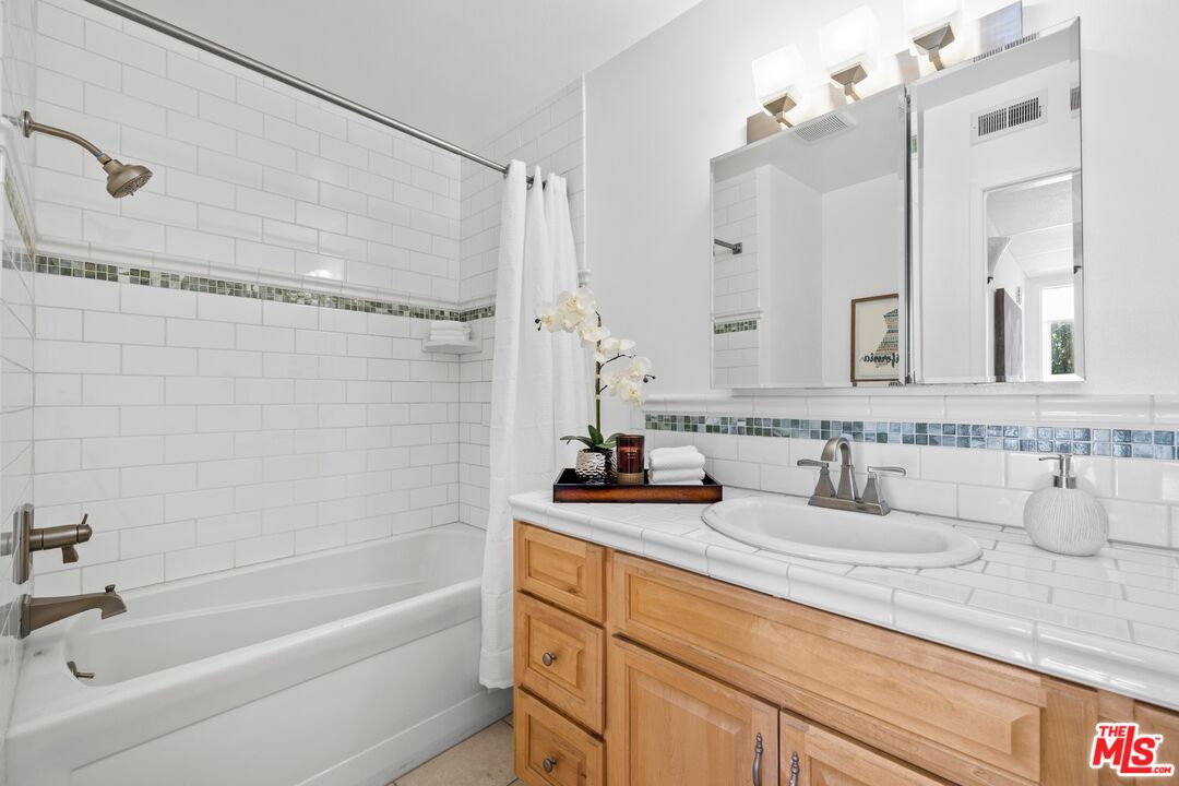 12720 Burbank Boulevard, Unit 318 Valley Village, CA 91607 - Photo 9 of 12 a bathroom with a sink and a mirror