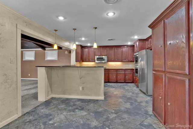 a kitchen with refrigerator and cabinets