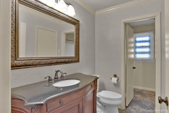 a bathroom with a toilet a sink and mirror